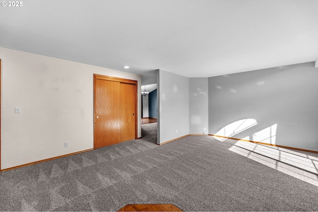 spare room with carpet and baseboards