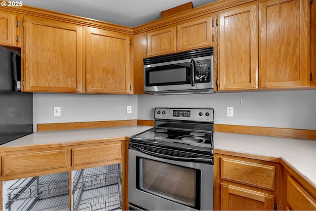 kitchen featuring stainless steel appliances and light countertops