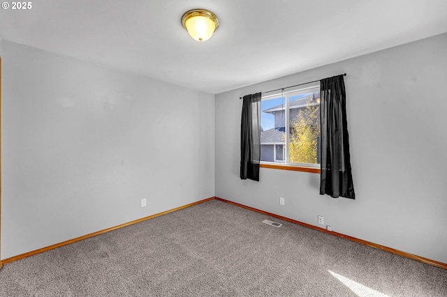 carpeted empty room with baseboards and visible vents