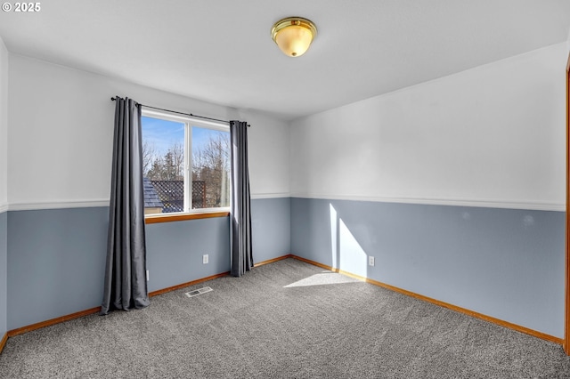 empty room featuring baseboards, visible vents, and carpet flooring