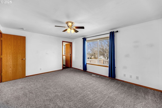 interior space with ceiling fan, carpet, visible vents, and baseboards