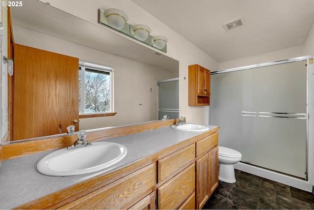 full bath with toilet, a stall shower, a sink, and visible vents