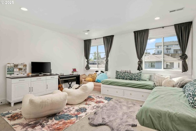 living area featuring light colored carpet and recessed lighting