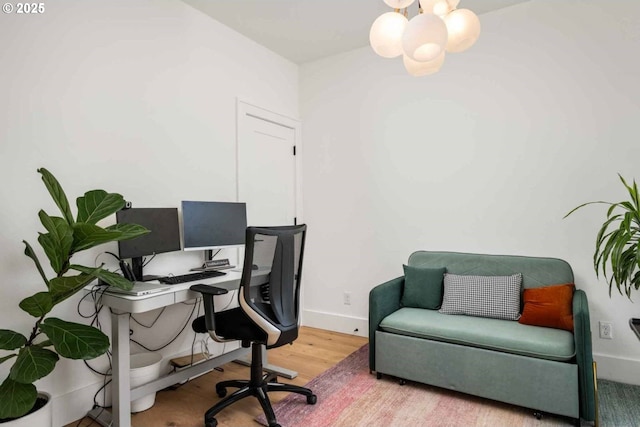 office featuring baseboards, wood finished floors, and a notable chandelier