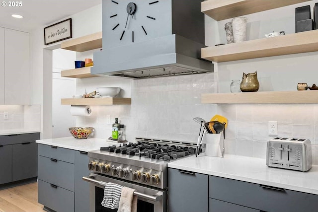 kitchen with open shelves, high end stainless steel range, gray cabinets, and tasteful backsplash