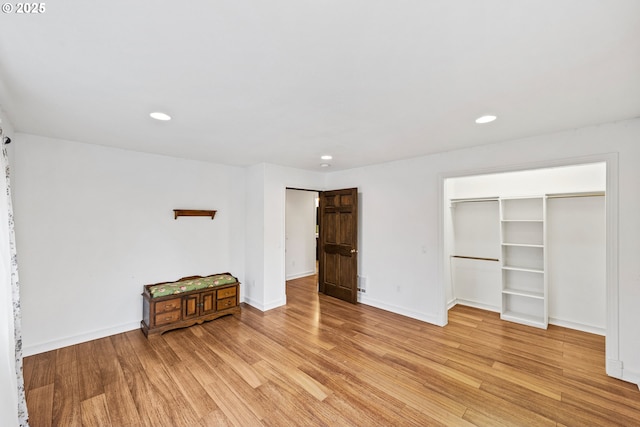 unfurnished bedroom featuring baseboards, light wood-type flooring, and recessed lighting