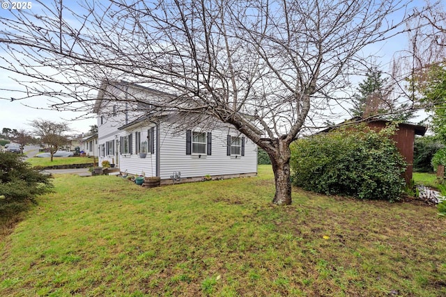 view of side of property featuring a yard