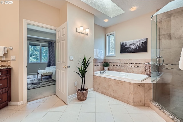 ensuite bathroom featuring a stall shower, a bath, a healthy amount of sunlight, and a skylight