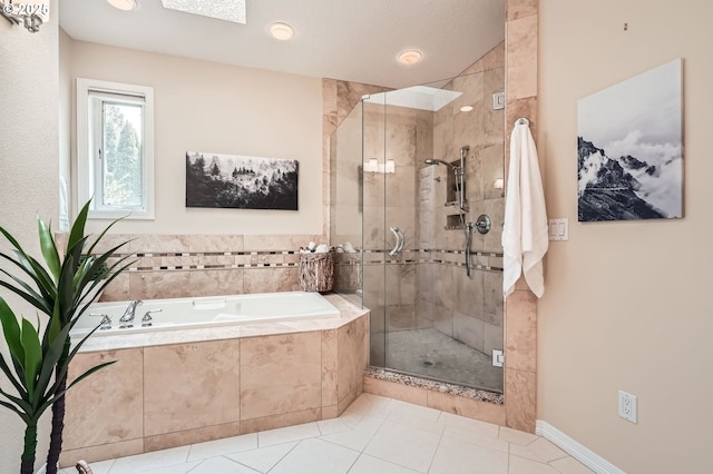 bathroom with a garden tub, a stall shower, and tile patterned flooring
