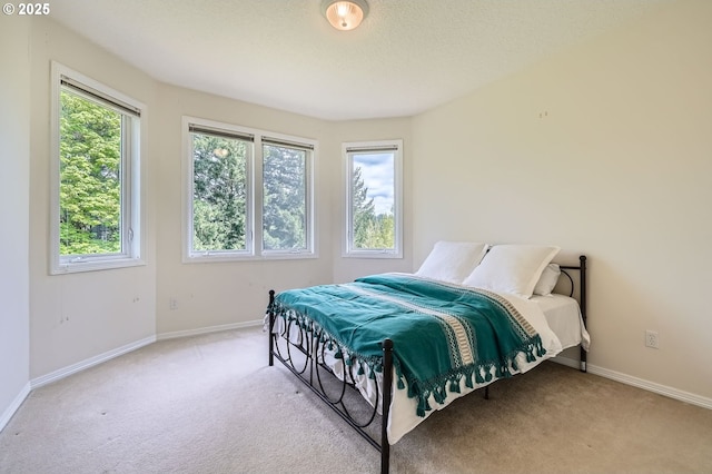 carpeted bedroom featuring baseboards