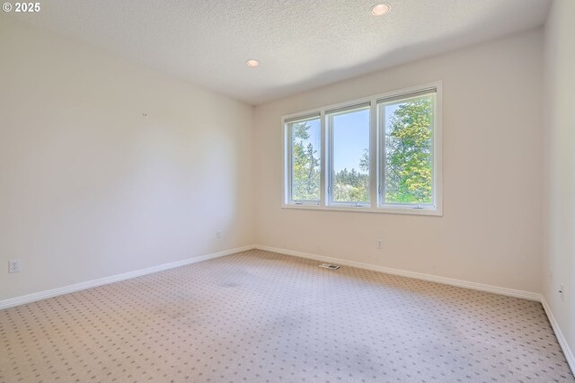 unfurnished room featuring light colored carpet, recessed lighting, baseboards, and visible vents