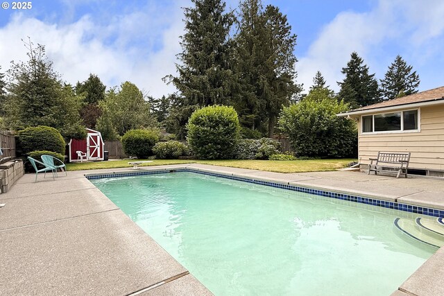 13275 NE Thompson Ct, Portland, OR 97230 - view of swimming pool with a storage unit, a fenced backyard, and a patio area