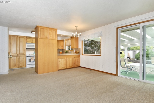13275 NE Thompson Ct, Portland, OR 97230 - unfurnished living room with light carpet, a chandelier, wallpapered walls, and a textured ceiling
