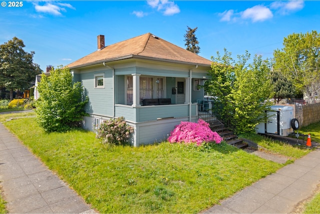 2104 N Rosa Parks Way, Portland, OR 97217 - view of front facade featuring a front yard, a chimney, stairway, and roof with shingles