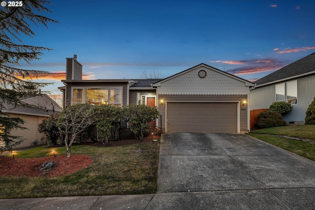 view of front of property featuring a yard and a garage