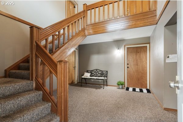 stairs with carpet floors and baseboards