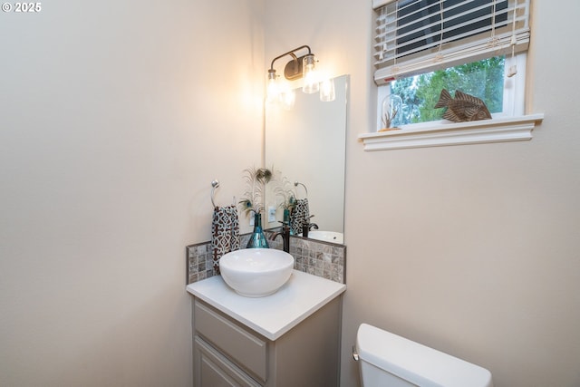 bathroom featuring toilet and vanity