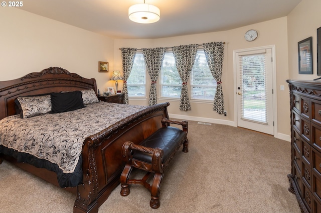 carpeted bedroom featuring baseboards, visible vents, and access to exterior