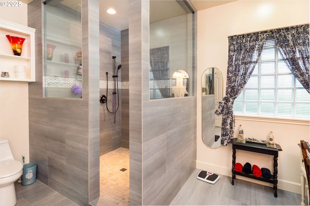 full bath featuring baseboards, toilet, and walk in shower