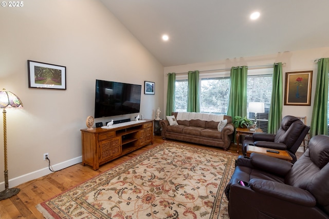 living room featuring light wood-style floors, recessed lighting, high vaulted ceiling, and baseboards