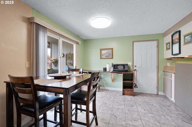 dining space featuring a textured ceiling