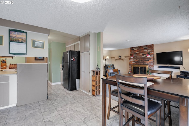 dining area featuring a textured ceiling and a fireplace