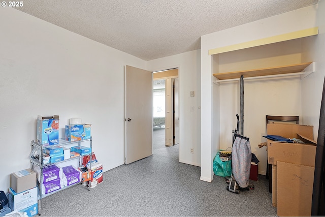 rec room with baseboards and a textured ceiling