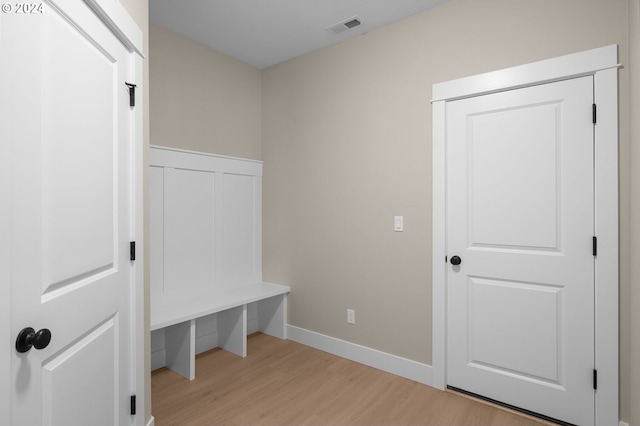 mudroom with visible vents, baseboards, and light wood-type flooring