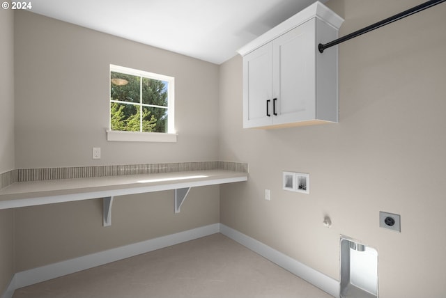 laundry area with cabinet space, hookup for a washing machine, gas dryer hookup, electric dryer hookup, and baseboards