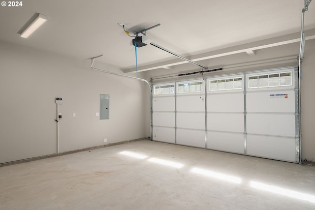 garage with a garage door opener and electric panel