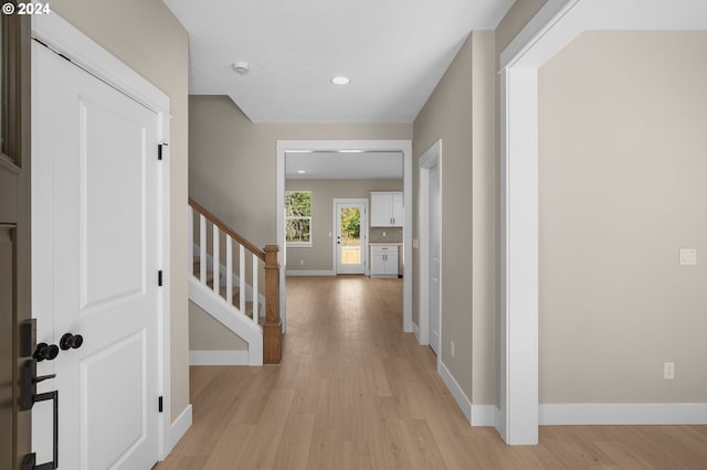 entryway with recessed lighting, baseboards, stairway, and light wood-style floors