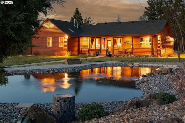 16830 Delicious St, Bend, OR 97703 - rear view of property with a lawn and a porch
