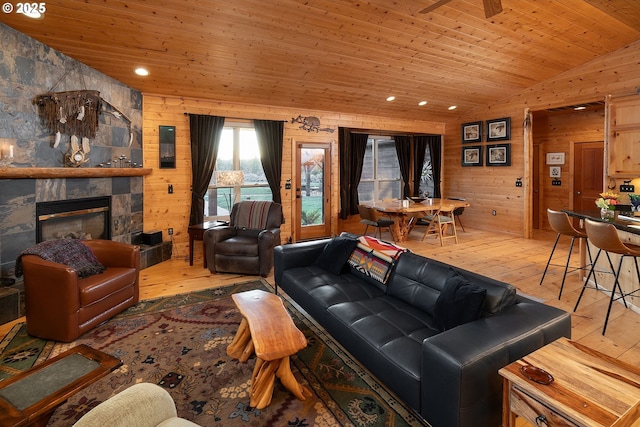 16830 Delicious St, Bend, OR 97703 - living area featuring hardwood / wood-style floors, wooden ceiling, lofted ceiling, wood walls, and a stone fireplace