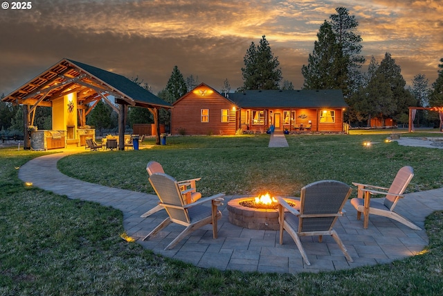 16830 Delicious St, Bend, OR 97703 - yard at dusk with a fire pit, a gazebo, a yard, and a patio