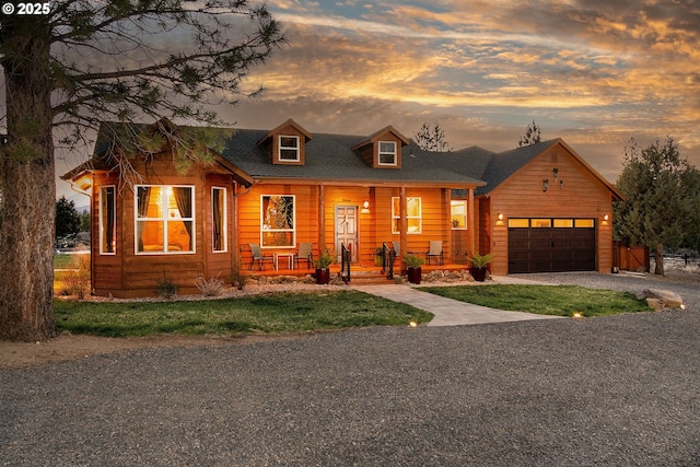 16830 Delicious St, Bend, OR 97703 - view of front facade with covered porch, driveway, a garage, and a yard