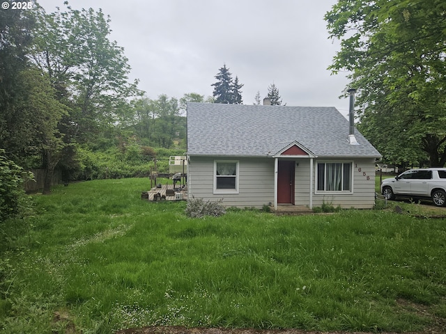 view of front of property featuring roof with shingles and a chimney