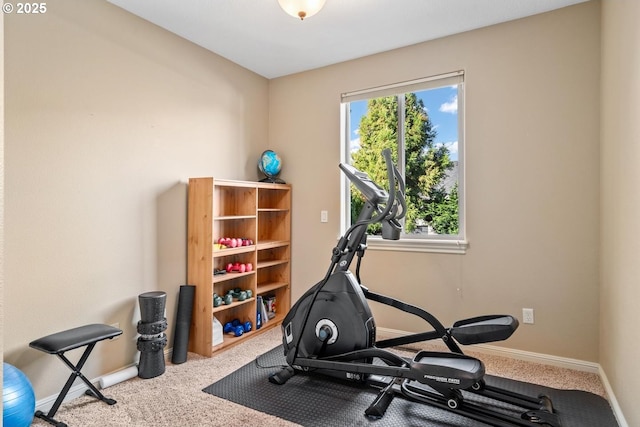 workout room with baseboards and carpet