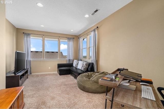 living room featuring baseboards, visible vents, carpet, and a wealth of natural light