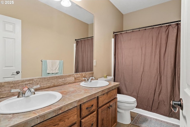 full bath with double vanity, a sink, tile patterned floors, and toilet