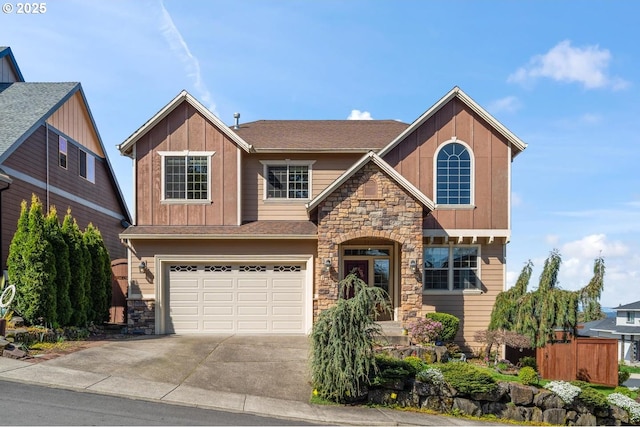 craftsman-style home featuring board and batten siding, a garage, fence, concrete driveway, and stone siding