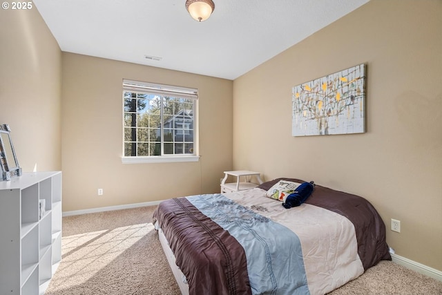 carpeted bedroom featuring baseboards and visible vents