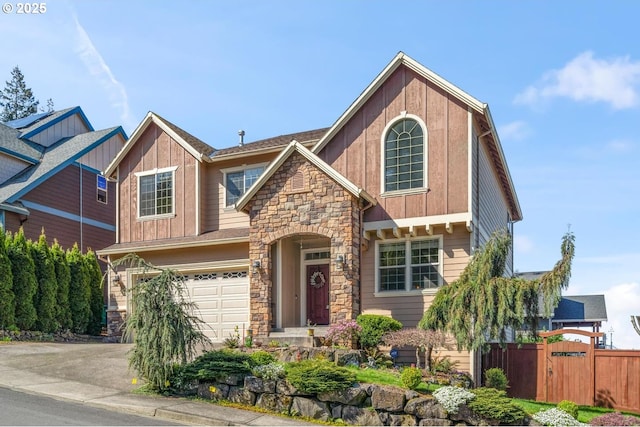 view of front of home featuring fence, stone siding, a garage, board and batten siding, and concrete driveway