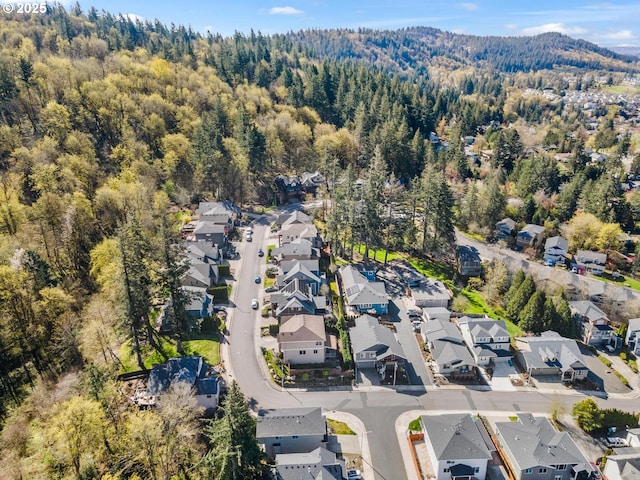 bird's eye view featuring a forest view and a residential view