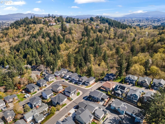 bird's eye view with a view of trees, a residential view, and a mountain view