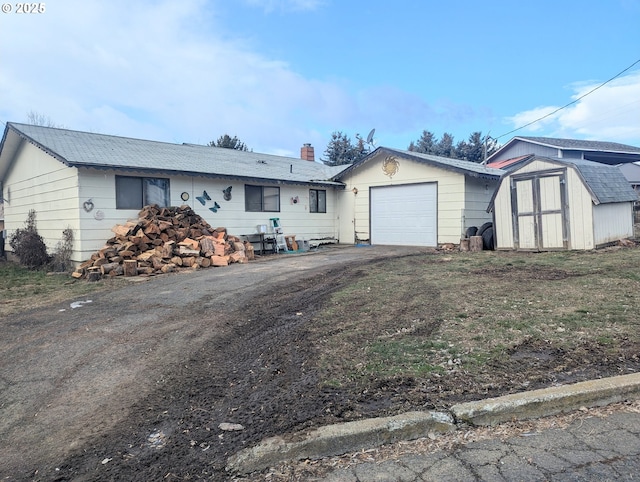 ranch-style home featuring a shed and a garage