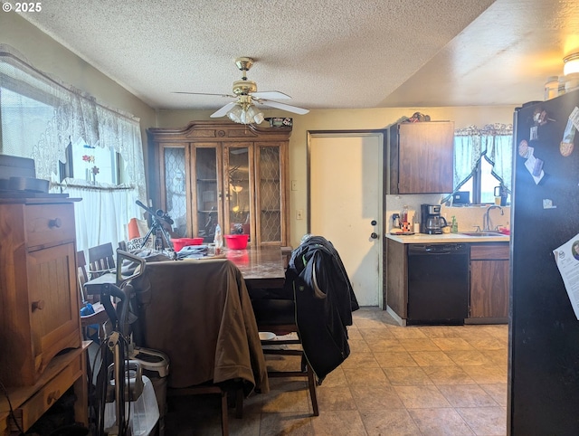 interior space with ceiling fan, dishwasher, a textured ceiling, refrigerator, and sink