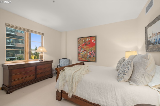 bedroom featuring light colored carpet