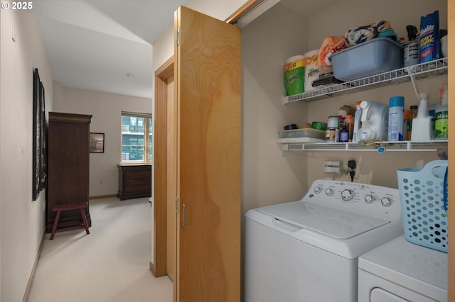 washroom featuring washer and clothes dryer and light carpet