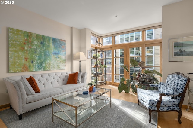 sitting room featuring wood-type flooring and french doors