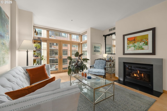 living room with light hardwood / wood-style flooring and floor to ceiling windows